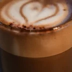 Café macchiato en petit verre, espresso taché d'une touche de mousse de lait en forme de cœur