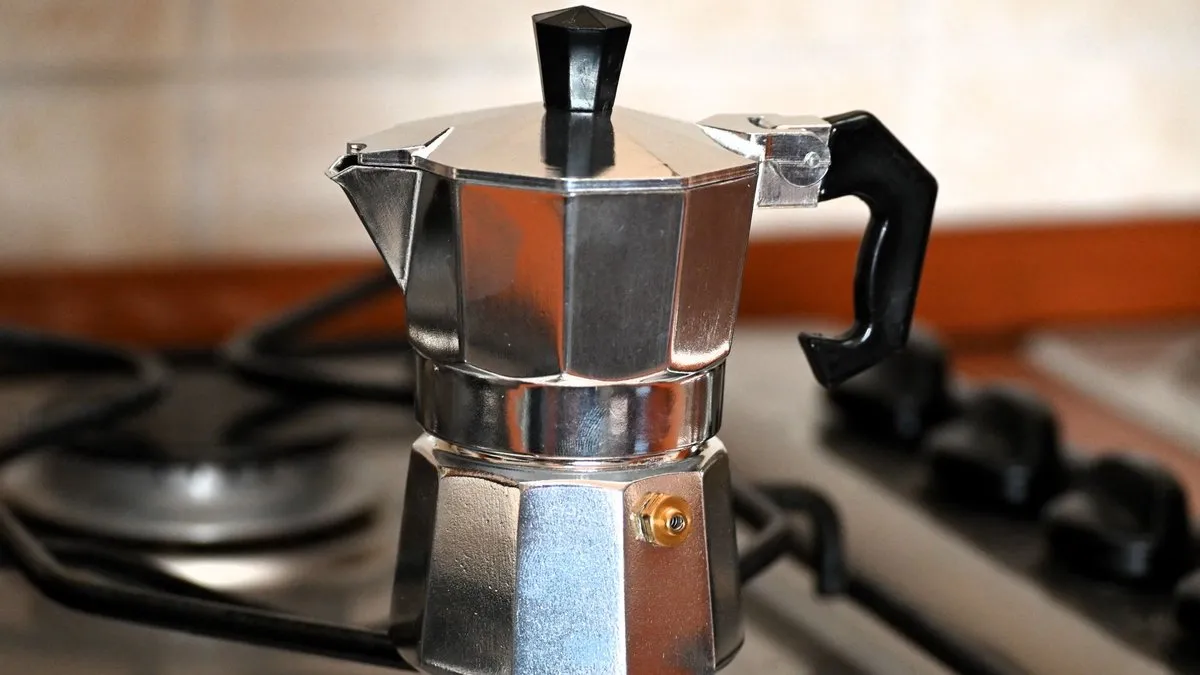 Cafetière italienne moka en aluminium posée sur une gazinière, prête à préparer le café